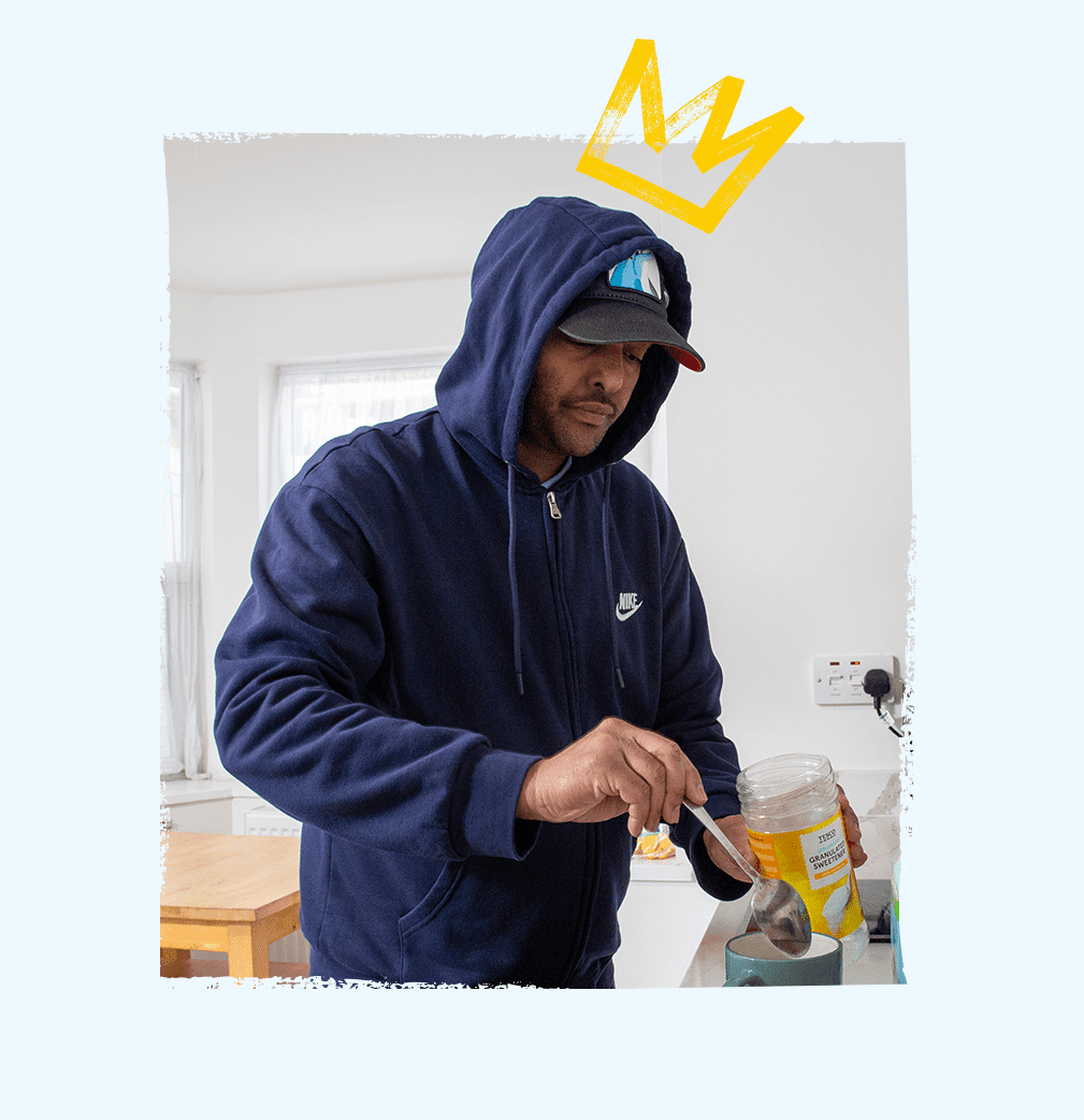 Service user preparing a cup of tea in a cozy kitchen setting