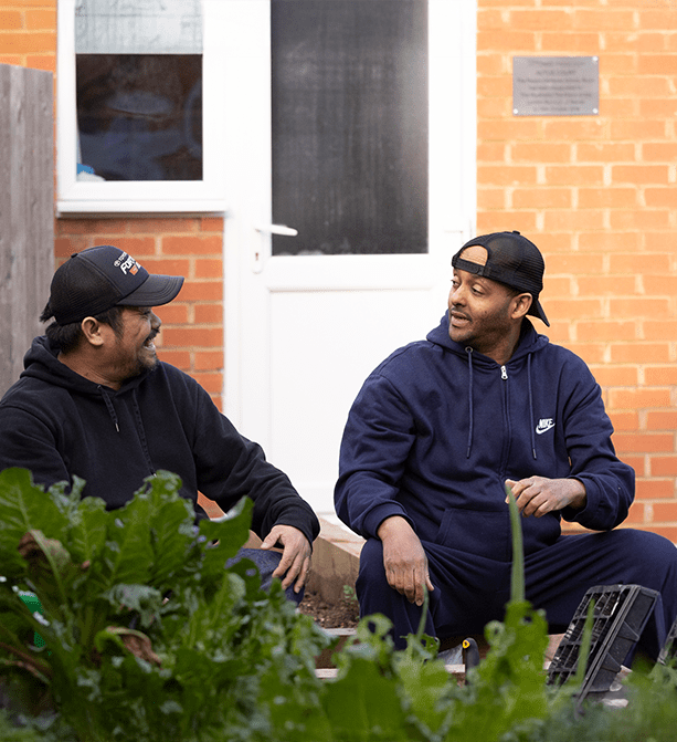 Service user and support working having a conversation in the garden